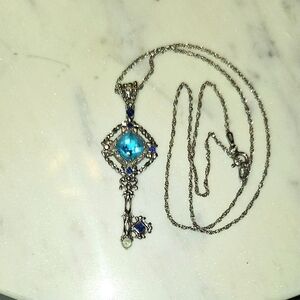 Intricate Silver Key Pendant Necklace with Blue Gemstone